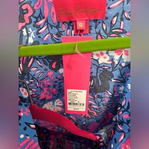 Two piece lilly Pulitzer outfit. top has button front with a tie bottom